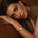 Mockberg Belle Oval Petite Bangle Watch dameklokke i gullfarget stål (large)
