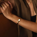 Mockberg Belle Oval Petite Bangle Watch dameklokke i gullfarget stål (large)